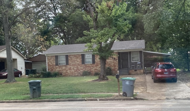 view of front of home with a front yard and a carport