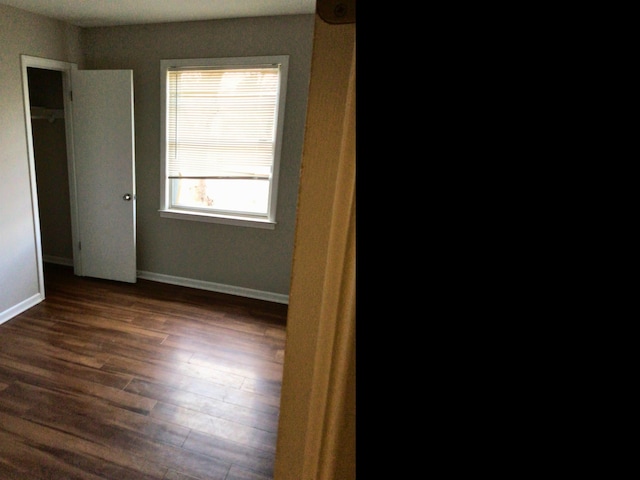 spare room with dark hardwood / wood-style flooring