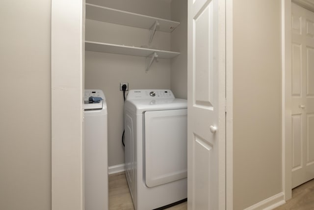 1111 N Watkins St, Memphis, TN 38107 - laundry area featuring separate washer and dryer and light wood-style floors