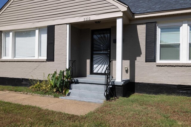 1111 N Watkins St, Memphis, TN 38107 - doorway to property featuring brick siding