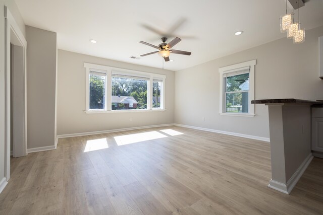 1111 N Watkins St, Memphis, TN 38107 - unfurnished living room with healthy amount of natural light, light wood finished floors, a chandelier, ceiling fan, and recessed lighting