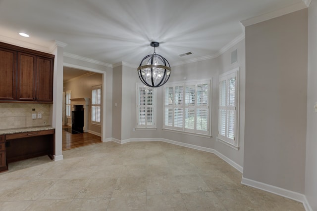 unfurnished dining area featuring an inviting chandelier and ornamental molding