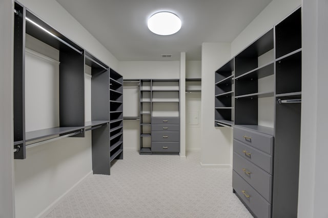 walk in closet featuring light carpet