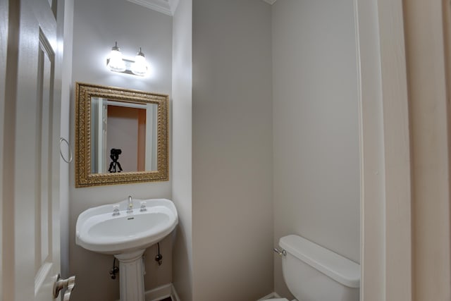 bathroom featuring toilet and ornamental molding