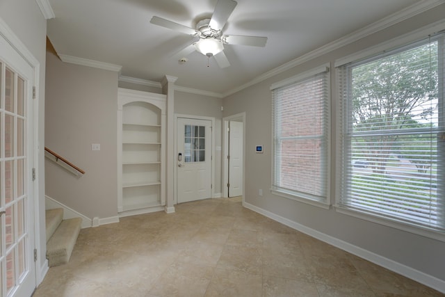 spare room featuring ceiling fan, a healthy amount of sunlight, and crown molding