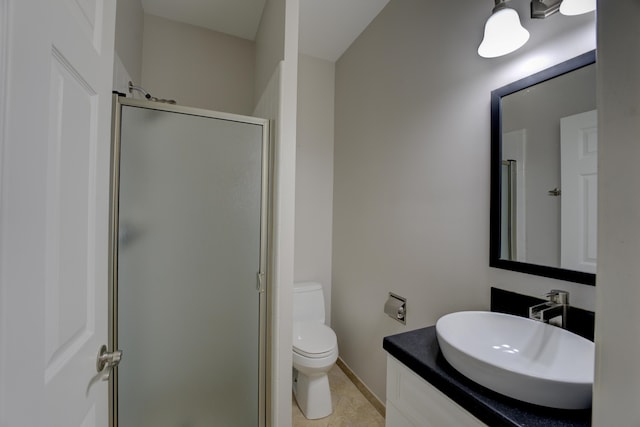 bathroom with tile patterned floors, vanity, an enclosed shower, and toilet