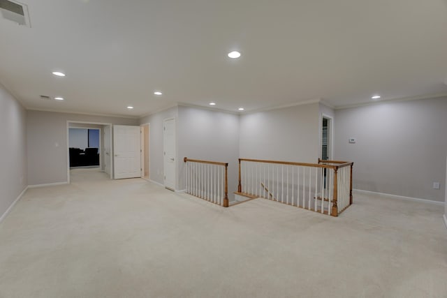 basement with light colored carpet and ornamental molding