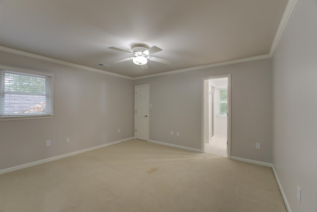 unfurnished room featuring ceiling fan, ornamental molding, and light carpet