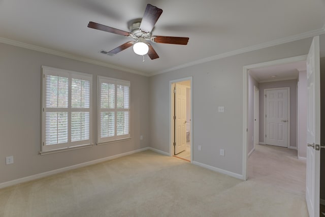 unfurnished bedroom featuring light carpet, ensuite bath, ceiling fan, and crown molding