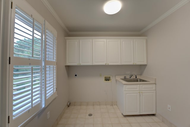 laundry area featuring ornamental molding, sink, cabinets, and washer hookup