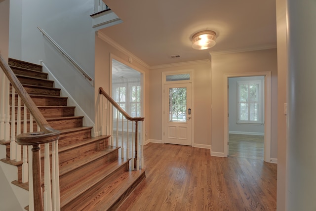 foyer entrance featuring wood-type flooring and ornamental molding