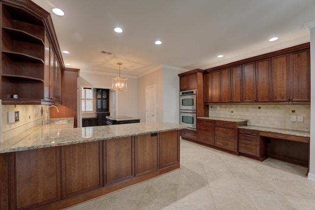 kitchen with backsplash, sink, double oven, light stone counters, and kitchen peninsula