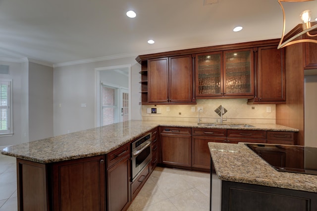 kitchen featuring sink, backsplash, kitchen peninsula, crown molding, and oven