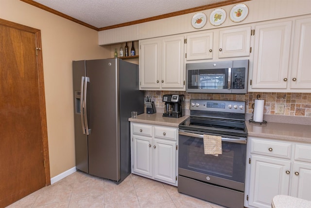 kitchen featuring appliances with stainless steel finishes, light tile patterned floors, and white cabinets