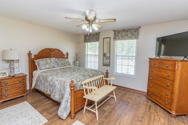 bedroom with ceiling fan and dark hardwood / wood-style flooring