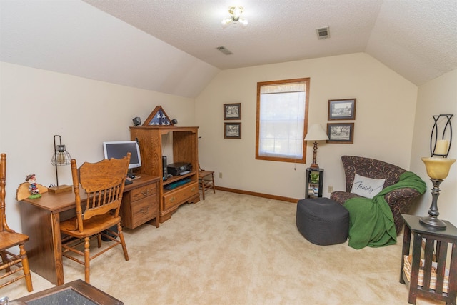 home office featuring lofted ceiling, light carpet, and a textured ceiling