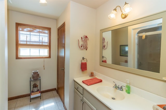 bathroom featuring tile patterned floors, a shower with shower door, toilet, and vanity