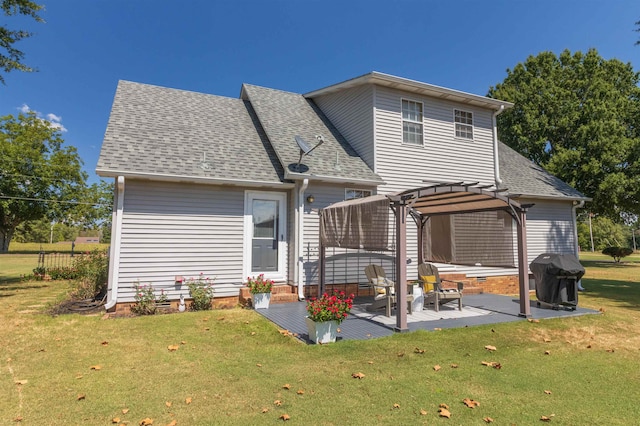 rear view of property featuring a pergola, a patio area, and a yard