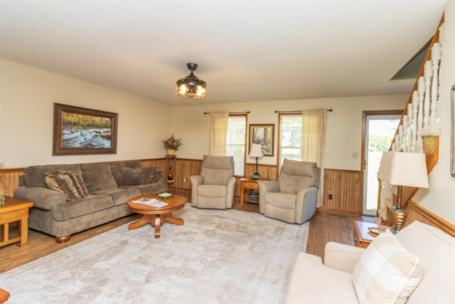 living room featuring wood walls and light hardwood / wood-style floors