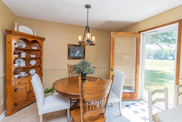 dining space featuring a chandelier and light tile patterned floors