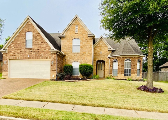 view of front of house with a front yard and a garage