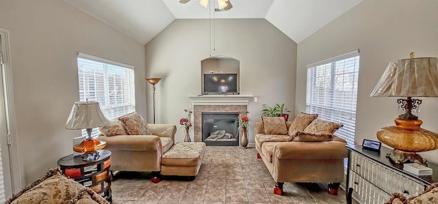 living room featuring a healthy amount of sunlight, a fireplace, and lofted ceiling