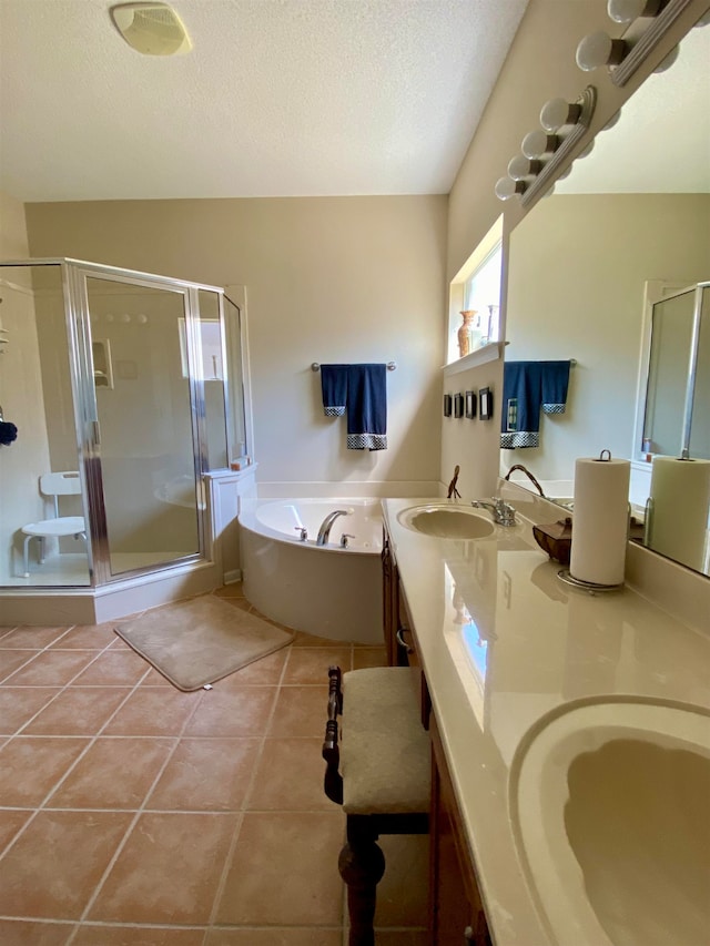 bathroom featuring vanity, a textured ceiling, tile patterned flooring, and shower with separate bathtub