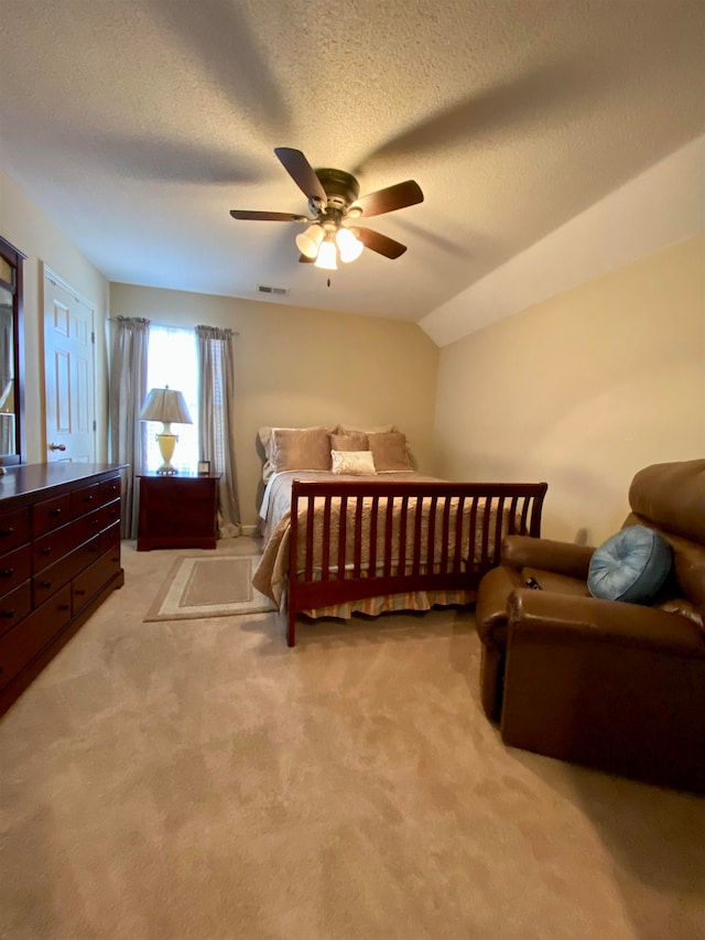 carpeted bedroom with lofted ceiling, ceiling fan, and a textured ceiling