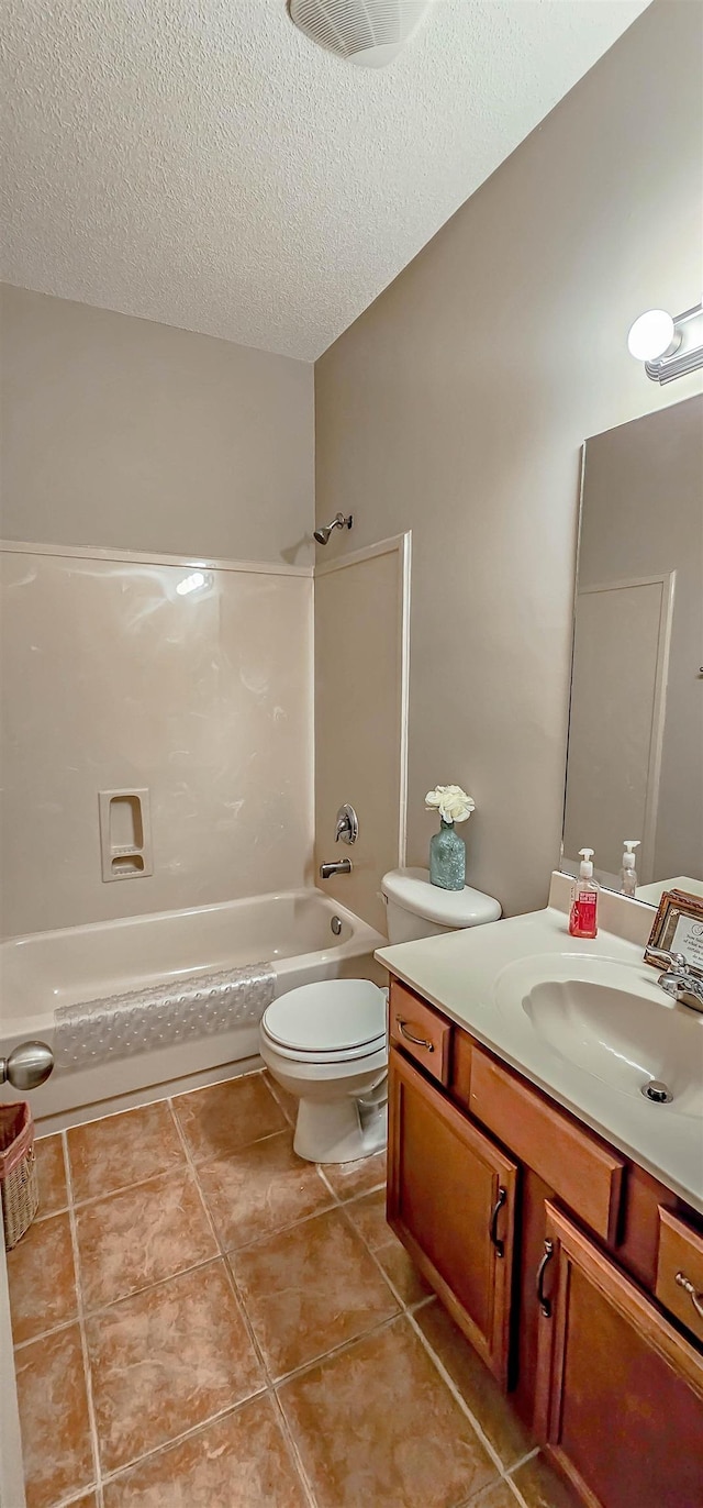 bathroom featuring a textured ceiling, toilet, vanity, bathing tub / shower combination, and tile patterned floors