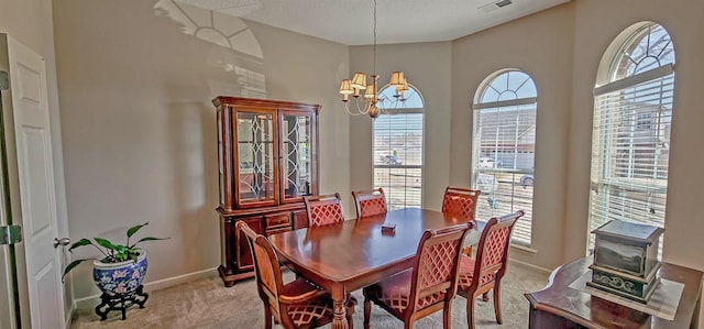 dining space featuring visible vents, a chandelier, baseboards, and light colored carpet