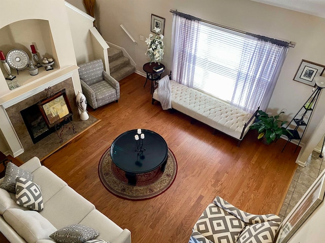 living room featuring wood-type flooring and a high end fireplace