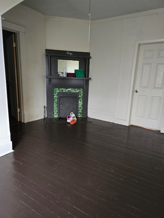 unfurnished living room with dark hardwood / wood-style flooring