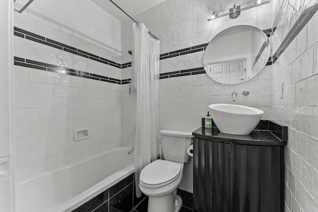 bathroom featuring toilet, tile walls, shower / bath combo, and vanity