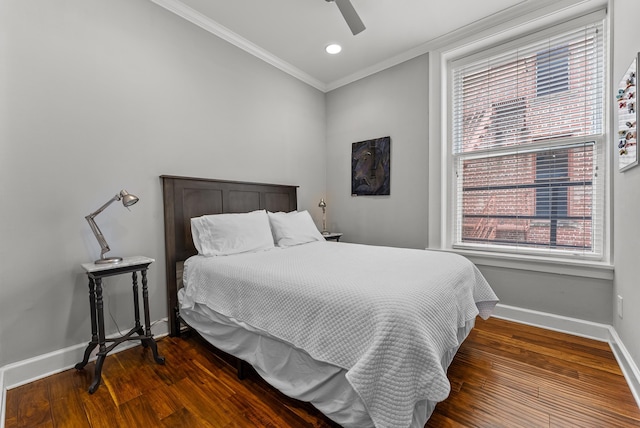 bedroom featuring ceiling fan, wood finished floors, baseboards, and ornamental molding