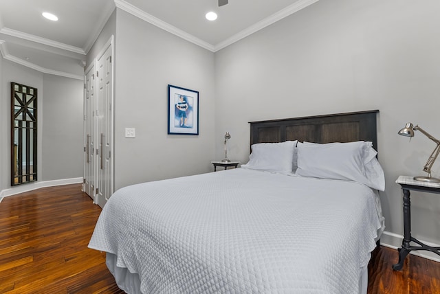 bedroom with recessed lighting, crown molding, baseboards, and wood finished floors