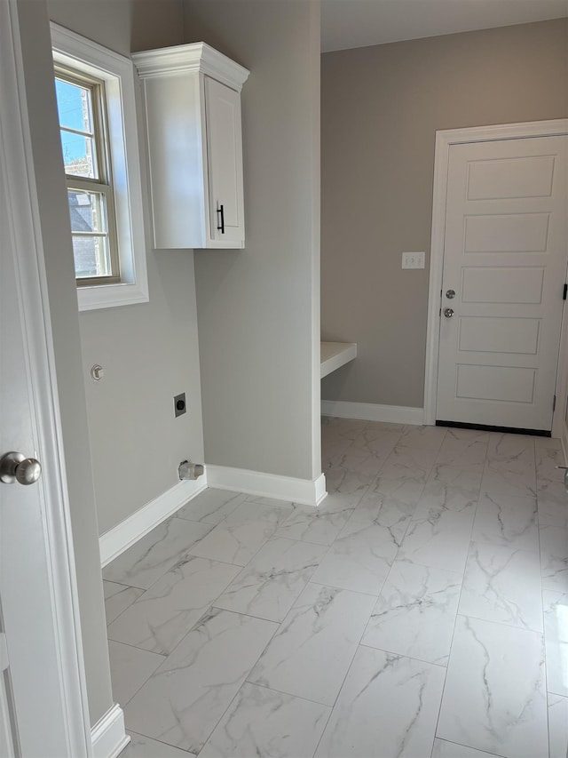 laundry area featuring baseboards, hookup for an electric dryer, marble finish floor, and cabinet space