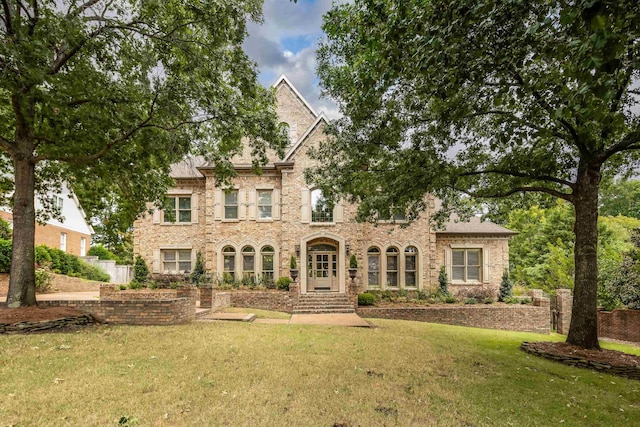 view of front of property with brick siding and a front yard