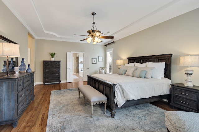 bedroom featuring ceiling fan, wood finished floors, visible vents, baseboards, and crown molding