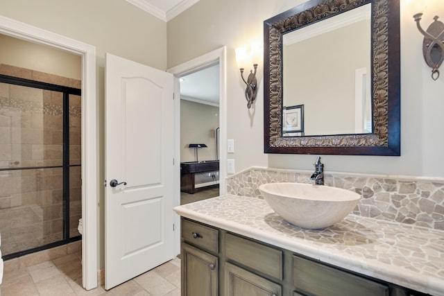 bathroom featuring a stall shower, crown molding, vanity, and toilet