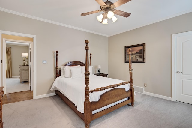 bedroom with light carpet, a ceiling fan, visible vents, baseboards, and ornamental molding