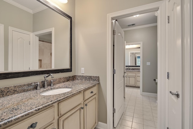 bathroom featuring baseboards, visible vents, ornamental molding, tile patterned floors, and vanity