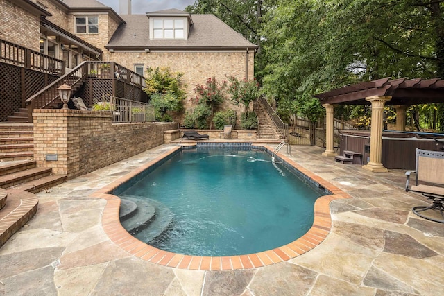 view of swimming pool with a hot tub, stairs, fence, a patio area, and a pergola