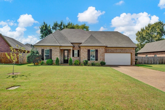 french country inspired facade featuring a front lawn and a garage