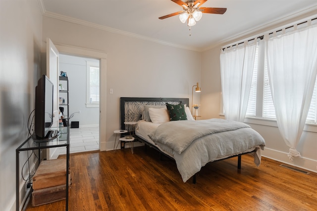 bedroom featuring ceiling fan, ornamental molding, and hardwood / wood-style floors