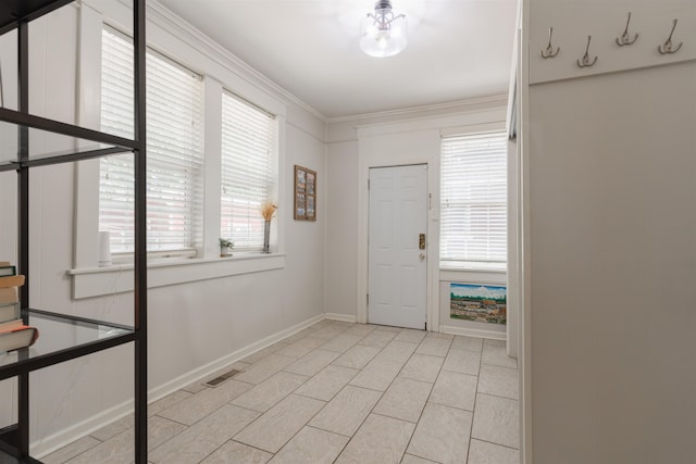 tiled foyer featuring ornamental molding