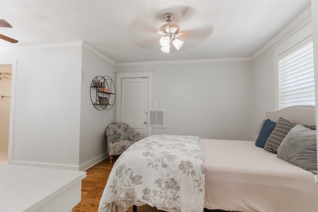 bedroom with a spacious closet, a closet, ceiling fan, ornamental molding, and hardwood / wood-style floors