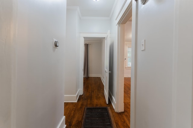 corridor with dark hardwood / wood-style floors and ornamental molding