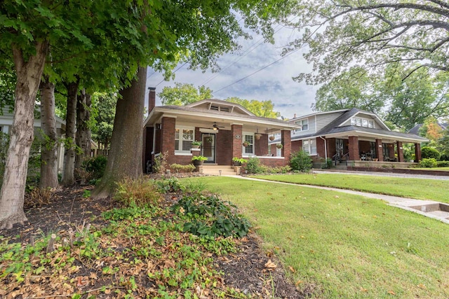 view of front facade with a porch, a front lawn, and ceiling fan