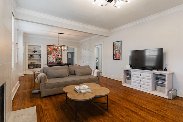 living room featuring ornamental molding, an inviting chandelier, dark wood-type flooring, and built in features