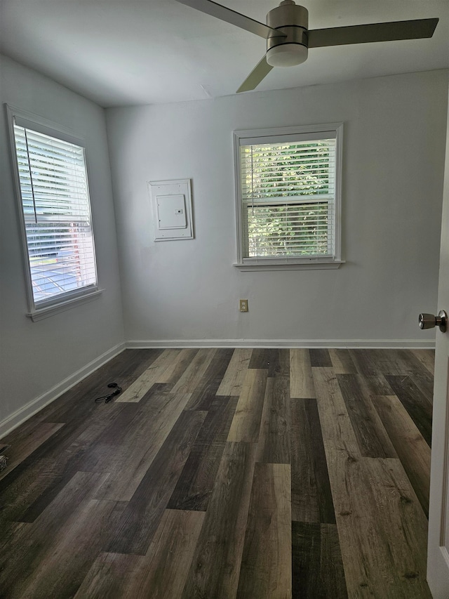 unfurnished room with ceiling fan and dark hardwood / wood-style flooring